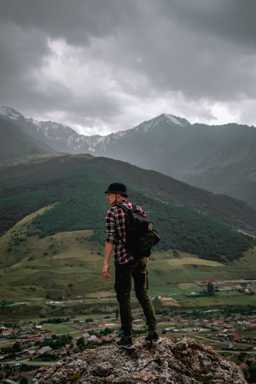 Travel writer reviewing notes on a mountain overlook