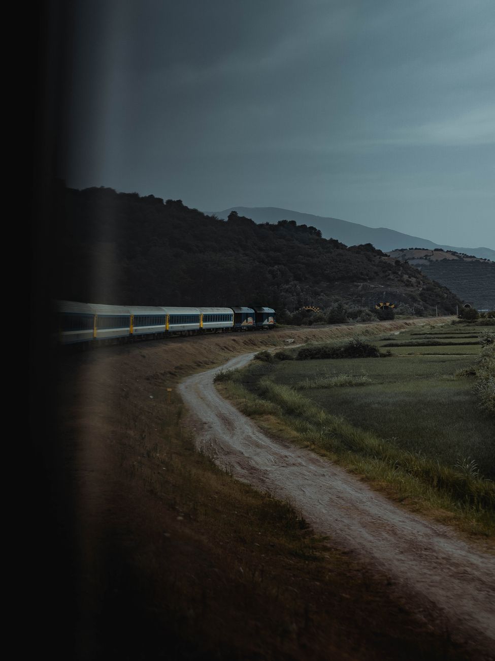 Scenic passenger train crossing mountain viaduct